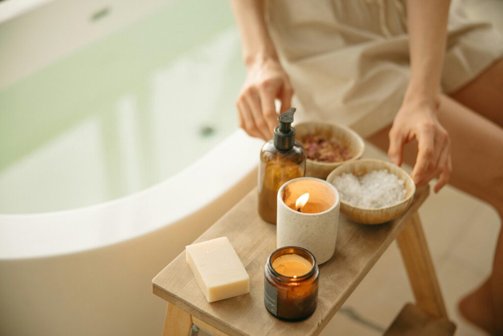 Calm spa setting with lit candles and bath products for a soothing atmosphere.